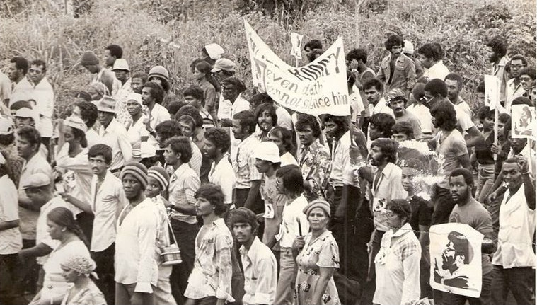 An archival black and white photograph of a large procession in Guyana
