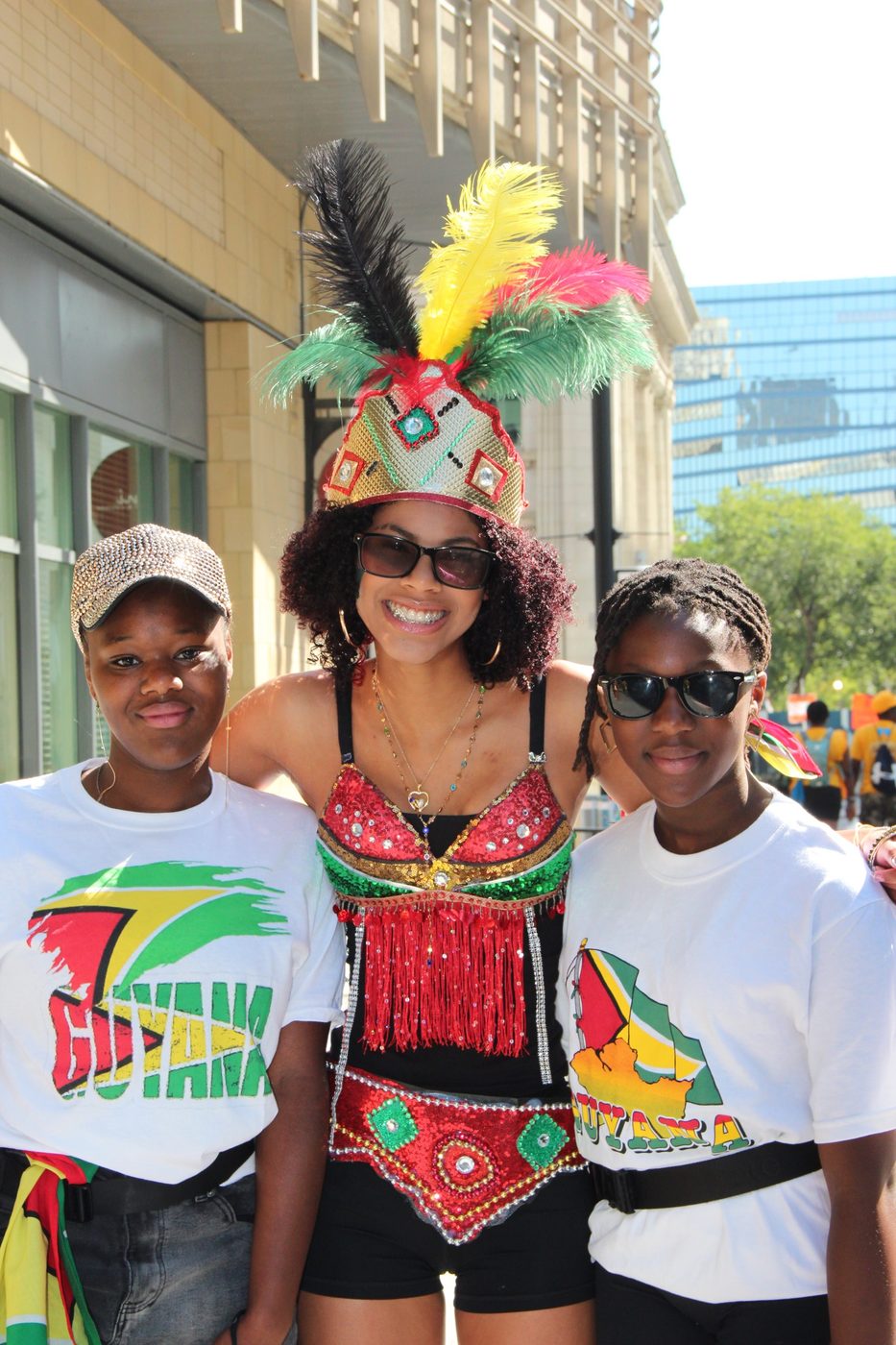 Three GCCA members on the route, one in costume and two in Guyana T-shirts