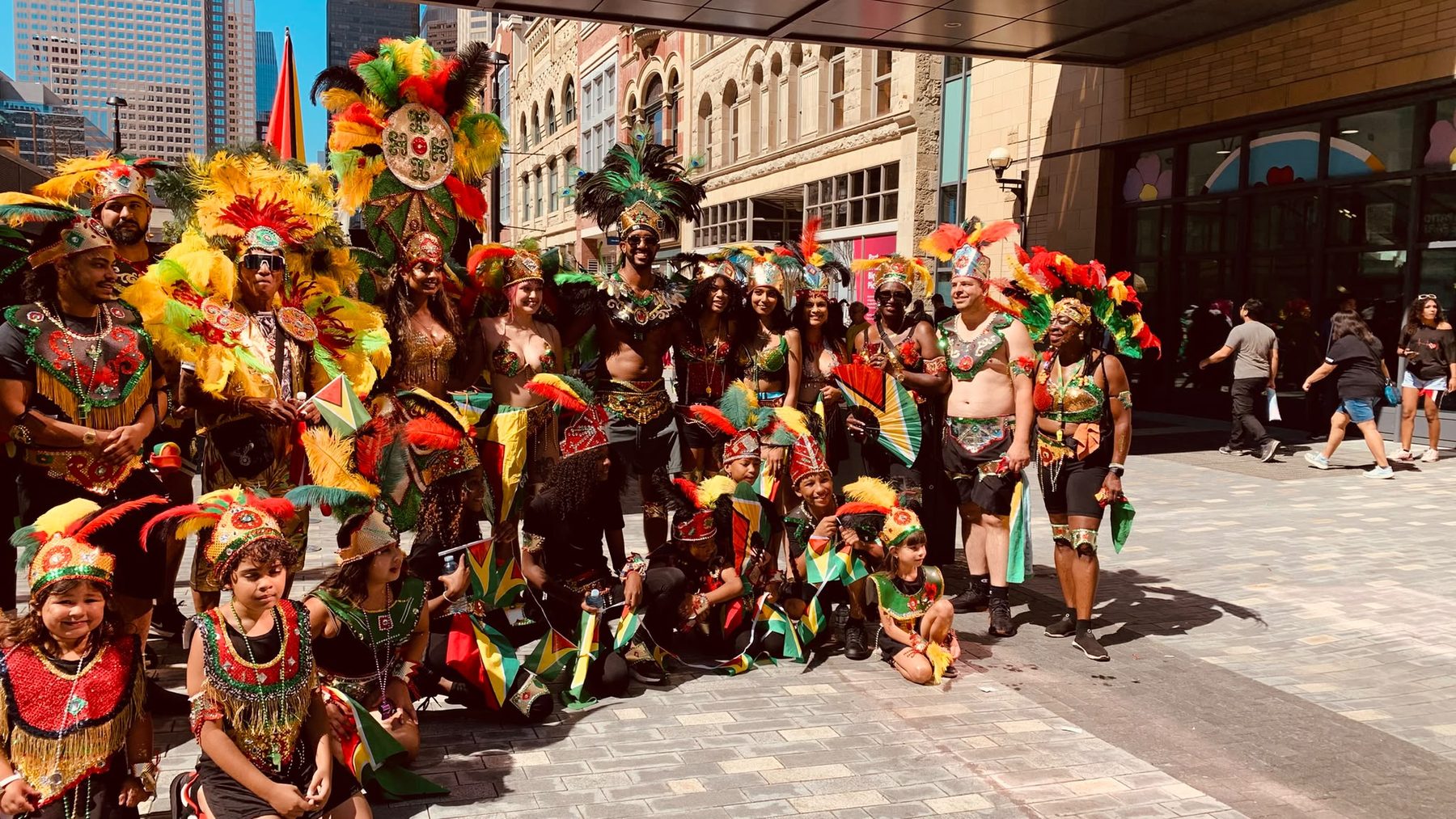 The GCCA band in full feathered costume gathered on a downtown Calgary street