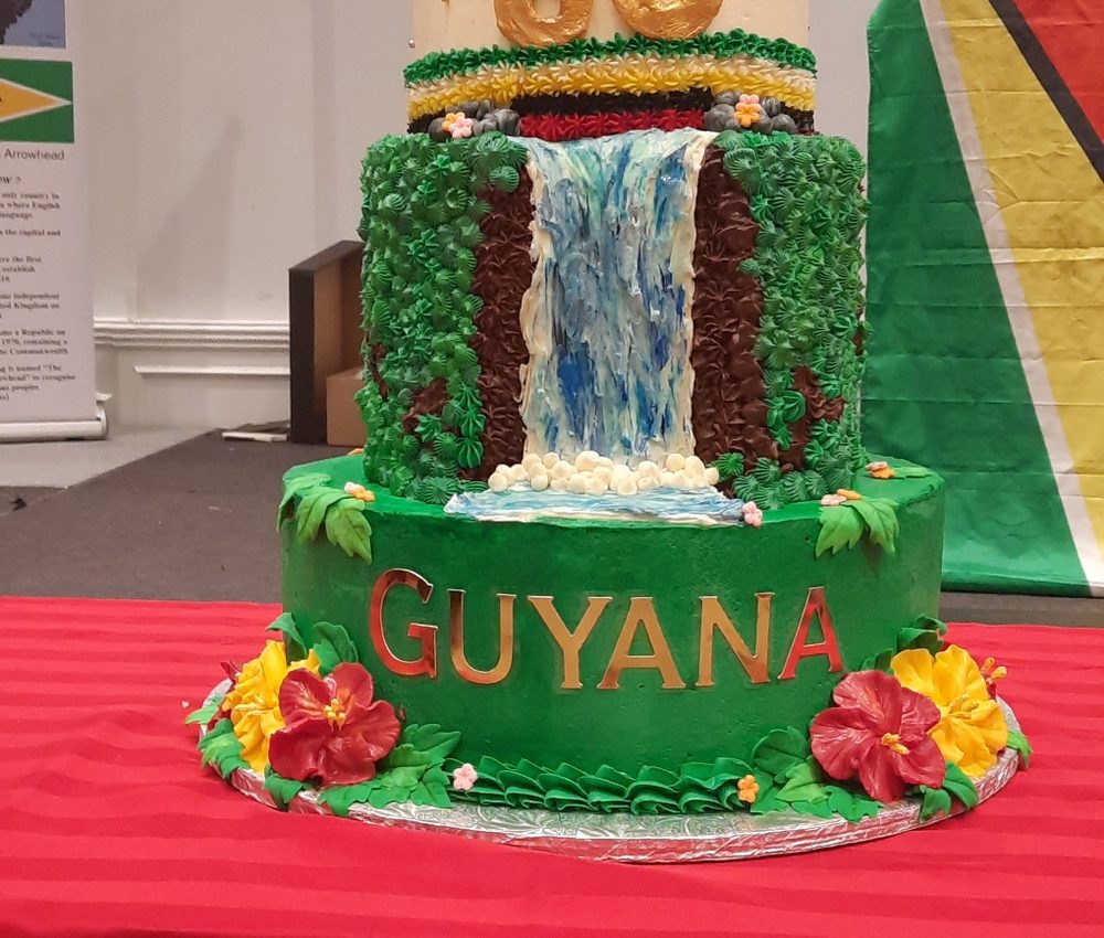 A tiered cake decorated with Kaieteur Falls and the word Guyana, made for the 60th Independence celebration