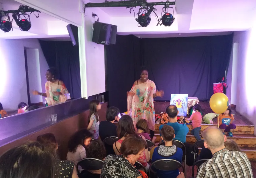 An elder sharing stories with children at a family gathering